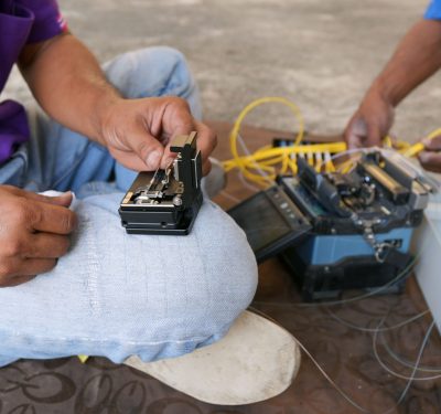 Technician working, fiber optic cable splicing and testing cable